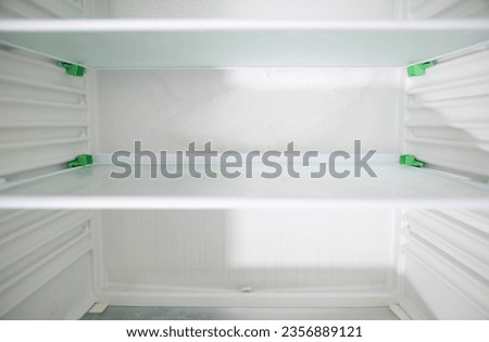 Ice and snow build up on the back wall of the refrigerator. Refrigerator failure, freon leak, temperature sensor defective. Royalty-Free Stock Photo #2356889121