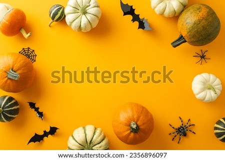 Halloween magic encapsulated: top view showcasing pumpkins, pattipans, spiders, cobweb, bats on orange backdrop. Text or ad placement available