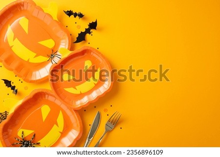 Elevate your Halloween gathering with this top view table setting idea. From unique tableware such as jack-o'-lantern plates to bat silhouettes. Creepy adornments like spiders on an orange backdrop