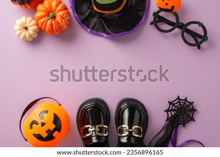 Indulge in Halloween trick-or-treat festivity with this bird's-eye top view photo featuring witch costume and Halloween ornaments on purple isolated backdrop, ideal for adverts or text incorporation