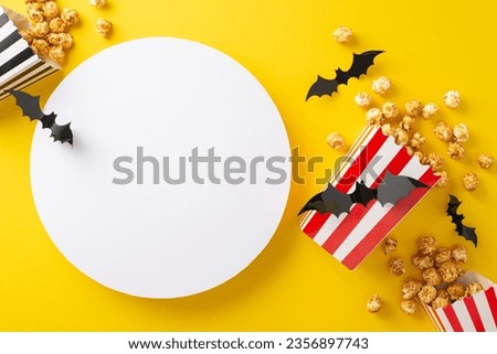 Halloween cinema under the stars with friends. Top view reveals themed decor, popcorn boxes, bat silhouettes on yellow backdrop with blank circle for advertising