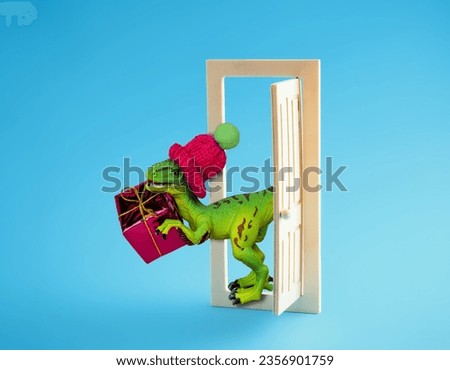 Dinosaur in a beanie holds  gift box and looks out of open door on blue background