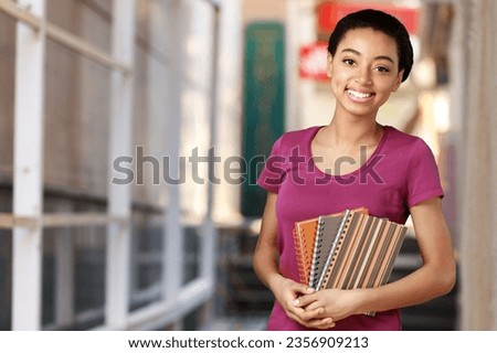 Young happy student portrait  in university background