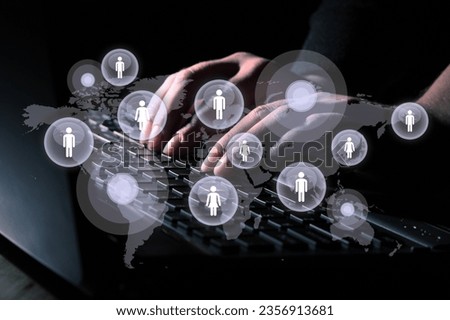 Young businessman using laptop with user icons