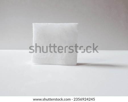 closeup of soft cotton pad in square shape isolated on white background
