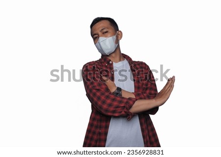 Asian young man wearing flannel shirt and medical mask. Air pollution concept.