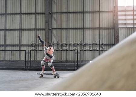 asian child skater or kid girl playing skateboard or ride surf skate up to wave ramp or wave bank to fun bottom turn and dab dance acting in skate park by extreme sports surfing to wears body safety Royalty-Free Stock Photo #2356931643