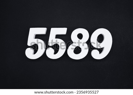 Black for the background. The number 5589 is made of white painted wood.