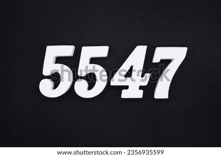 Black for the background. The number 5547 is made of white painted wood.
