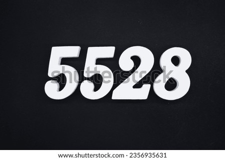 Black for the background. The number 5528 is made of white painted wood.