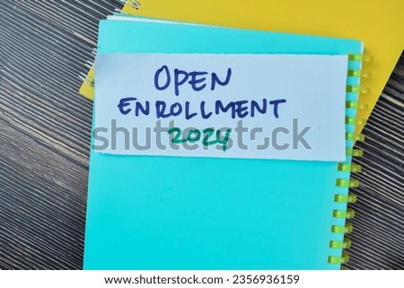 Concept of Open Enrollment 2024 write on sticky notes isolated on Wooden Table.