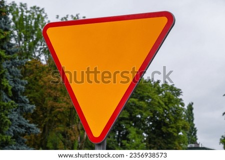 Road sign triangle"Give way" on a natural background with mockup and copyspace