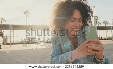 Girl takes a photo of friends on a mobile phone, Backlighting