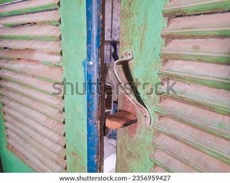 Old wooden entrance door with antique door handle or old door knob.