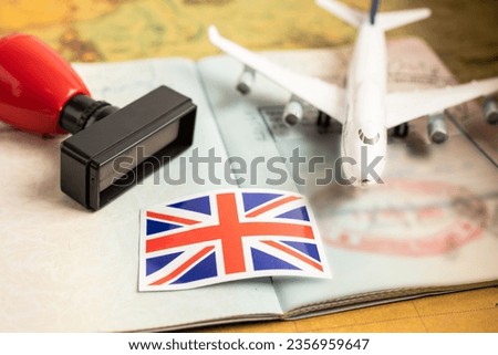 Approved Stamp visa and passport with United Kingdom flag document to immigration at airport in country.