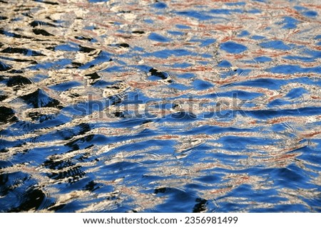 The surface of the water in which the sky is reflected. Selective focus area.