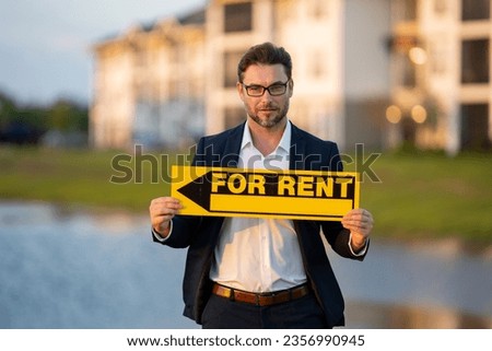 Real estate agents hold sign for rent. Housing estates in the project, buying and tenting housing estates. Real estate trading ideas and bank loans for renting houses. Rent home, rental concept.