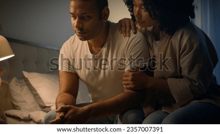African American woman wife girlfriend calming comforting support sad upset offended man apologizing ask forgiveness after family couple quarrel conflict in bed at night erectile dysfunction problem Royalty-Free Stock Photo #2357007391