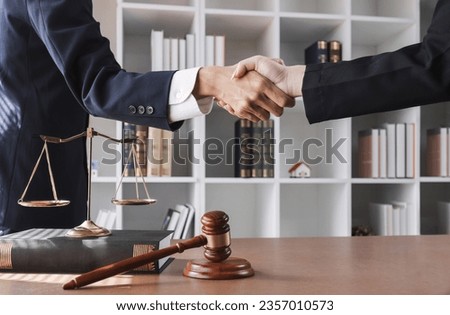 legal advice A lawyer shakes hands with a client after a successful consultation. Royalty-Free Stock Photo #2357010573