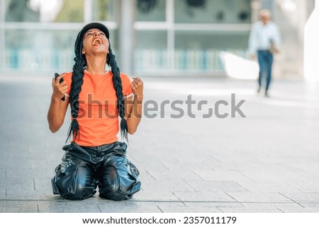 girl on the street celebrating success with joy Royalty-Free Stock Photo #2357011179
