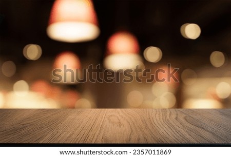 Mock up for space. Empty dark wooden table in front of abstract blurred bokeh background of restaurant . can be used for display or montage your product.