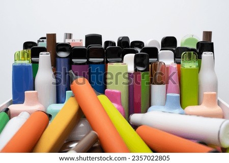 Synthetic nicotine concept. Various disposable electronic cigarettes. modern alternative smoking, vaping and nicotine. Close up Royalty-Free Stock Photo #2357022805