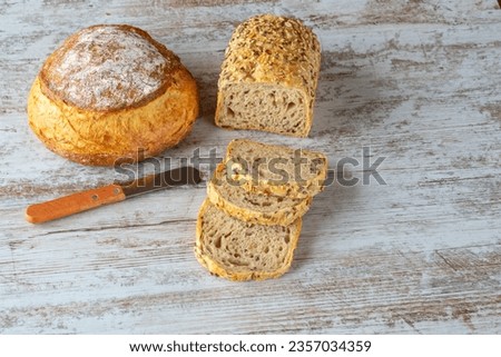 Different types of bread cut into slices and whole Royalty-Free Stock Photo #2357034359