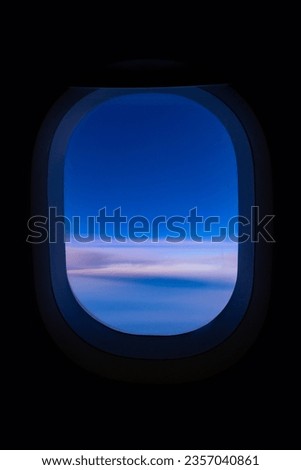 View looking blue sky through an airplane window