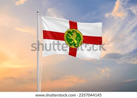 Alderney flag waving on sundown sky