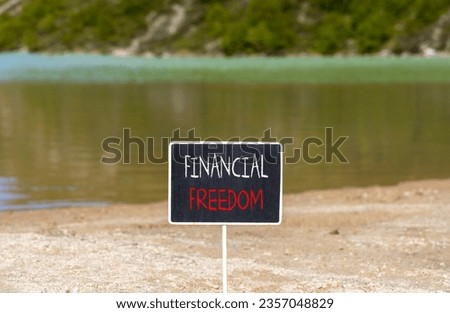 Financial freedom symbol. Concept words Financial freedom on beautiful black chalk blackboard. Chalkboard. Beautiful mountain lake background. Business financial freedom concept. Copy space.