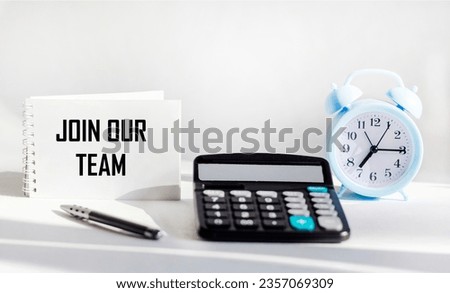 Join our team text on notepad and white background with calculator and clock