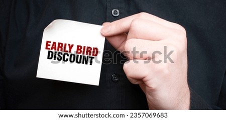 Businessman holding a card with text EARLY BIRD DISCOUNT, business concept