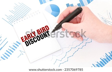 Businessman holding a black marker, notepad with text EARLY BIRD DISCOUNT, business concept