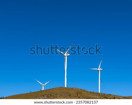Aerial view of wind turbines and agriculture field. High quality photo