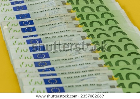 Money scattered on the table one hundred and two hundred Euro banknotes