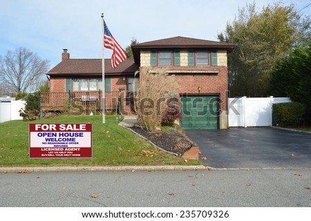 American flag pole Real Estate for sale open house welcome sign suburban home back split snout style in residential neighborhood USA