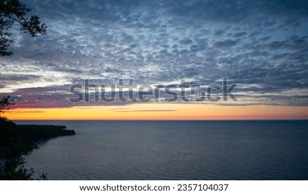 Beautiful sunset at the Log Slide Overlook lookign West at the Au Sable Lighthouse in Pictured Rocks National Lakeshore, MI. This iconic spot features the great Lake Superior in Pure Michigan fashion.