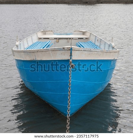 Close up of the bow of a small blue boat on a lake. A photo from holidays. Marine picture.