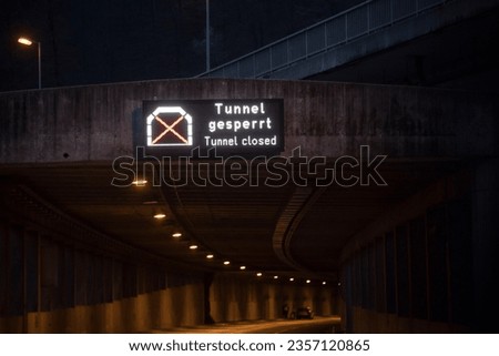 Tunnel closed (Tunnel gesperrt) LED sign at the entrance of a road tunnel at night