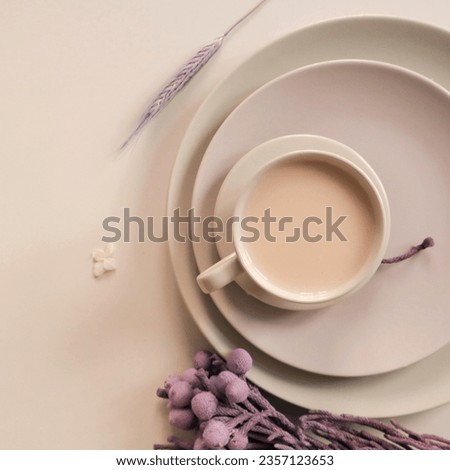 A cup of coffee on beige plates with purple flowers. Morning breakfast. Top view, space for text. High quality photo
