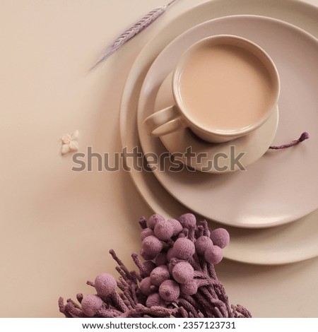 A cup of coffee on beige plates with purple flowers. Morning breakfast. Top view, space for text. High quality photo