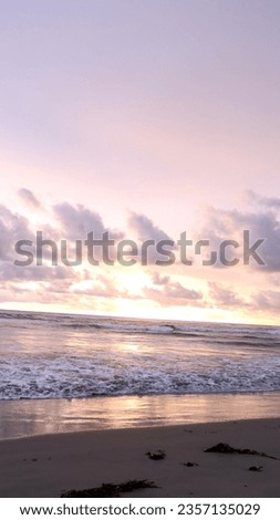 sunset on the beach with a beautiful dark and orange sky