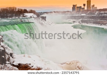 Snow Covered American Falls  Flowing Into the Niagara River with the Skyline of Niagara Falls, Ontario, Canada in the Distance, Niagara Falls, New York, USA
