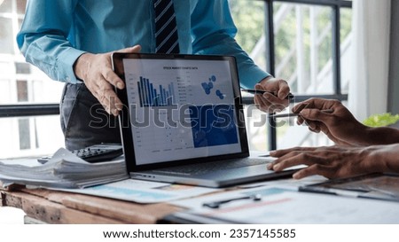 Asian business advisor meeting to analyze and discuss the situation on the financial report in the meeting room.Investment Consultant. Royalty-Free Stock Photo #2357145585