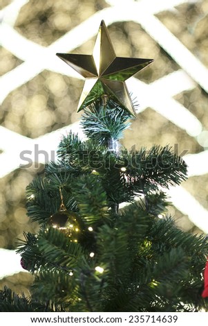 Star on Christmas tree with bokeh