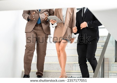 business partners walking down in office building and talking