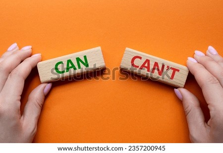 Can or Cant symbol. Concept word Can or Cant on wooden blocks. Businessman hand. Beautiful orange background. Business and Can or Cant concept. Copy space