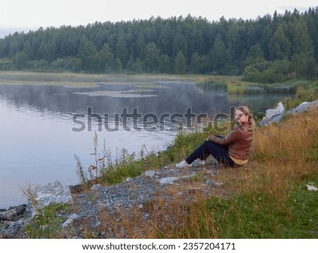 Woman sitting on the coast. Woman sitting in the park