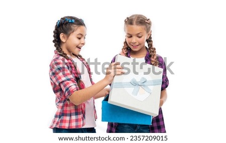 children girls sharing gift. gift to friend. gift box from shopping. children girls with boxes. happy birthday. birthday gift box. Curious girls examining the items inside the box with wonder
