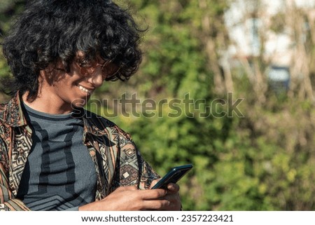 young black man with mobile phone outside